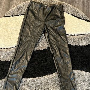 Black pleather pants. Zip and button side. Pleated down the front. Skinny leg.